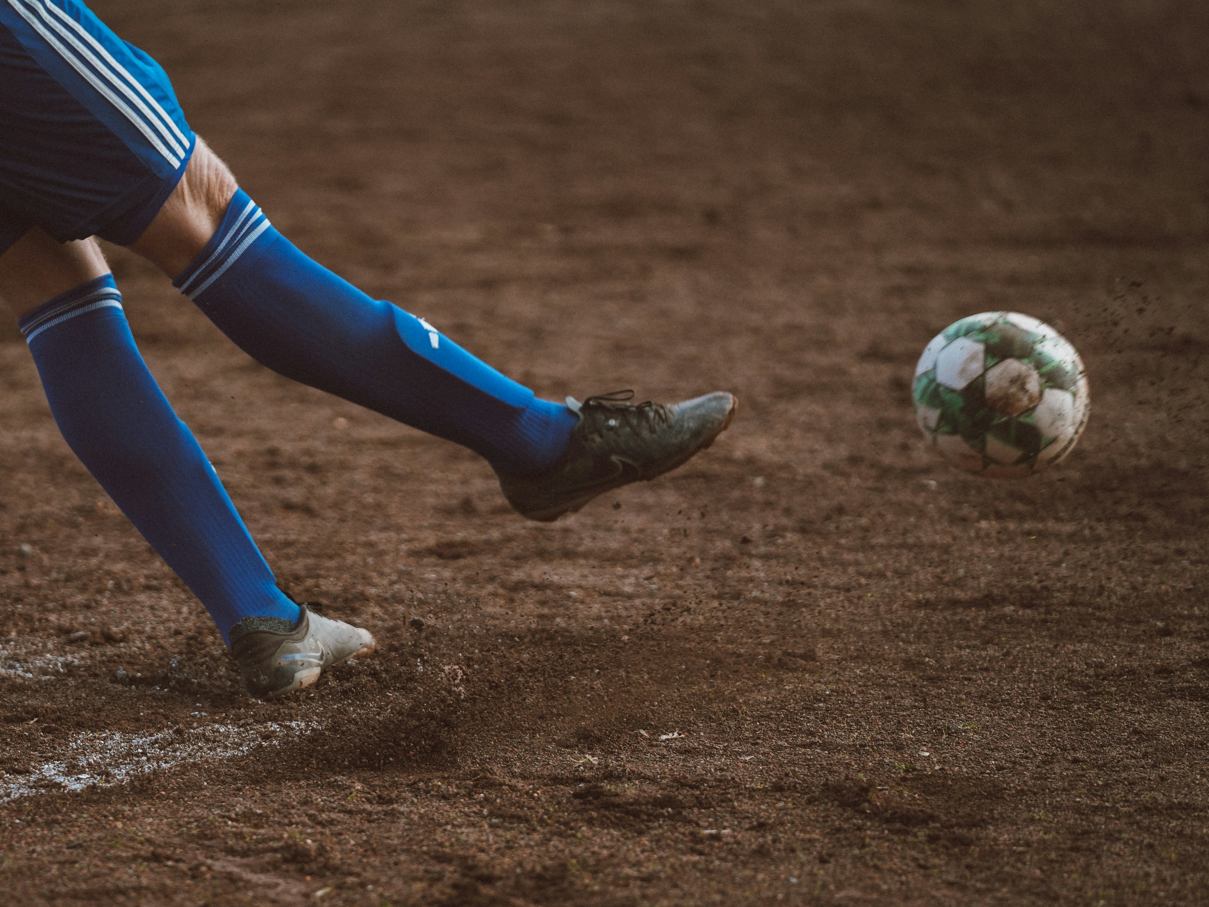 A person kicking a soccer ball